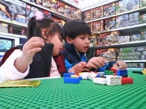 This is a picture of kids enjoying Magformers magnetic tiles in their playroom. Magformers magnetic tiles are one of the best toys you can buy for your kids! Buy these magnetic toys today! 