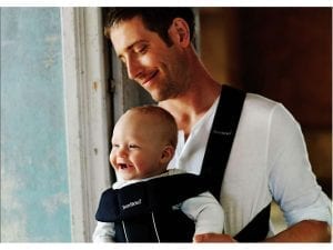 A father using a BabyBjorn carrier.