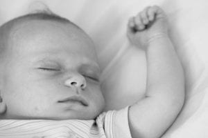 The toddler is sleeping. The toddler can achieve this kind of sleep when an infant has a good lounger to use. 