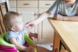 A baby sitting on a high chair - the best chair 