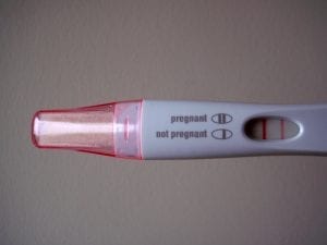 A photo of a pregnancy test with two lines, which means the pregnancy calculator test is positive. You can find out when you're estimated to give birth by using a due date calculator. Simply input the necessary information to find out your delivery time.