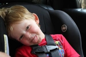 A joyful baby sitting comfortably in a baby car convertible seat. The perfect convertible car seat ensures their safety and comfort during travels, providing peace of mind for parents. Thanks to the perfect car convertible seats.