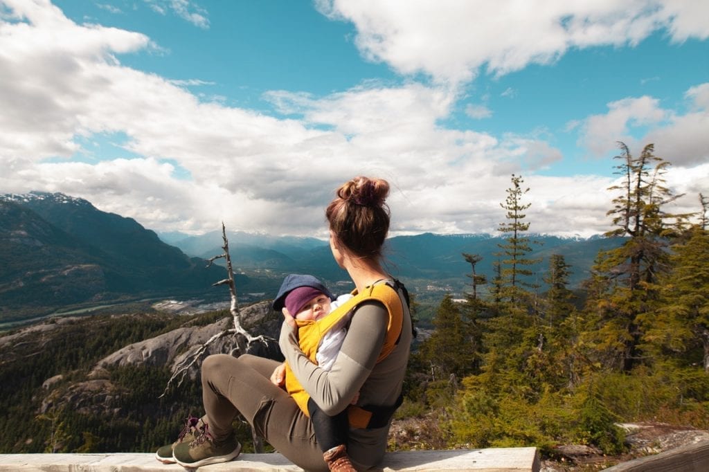 A mother and baby using a baby Tula carrier or simply a carrier. She took her little one with baby Tula carrier securely and safely. Their bond subtly echoed through the untouched wilderness with the help of a baby Tula carrier. Choose a carrier you can trust and a carrier that is comfortable.