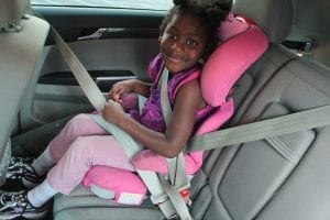 A child on her booster car seat