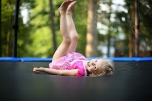 A little girl playing on trampoline