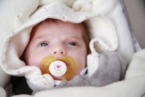 A baby going to sleep on an auto-craddler sleeper. Rock a baby to sleep by letting her suck a pretend nipple on her mouth