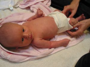 A newborn baby wearing a pads