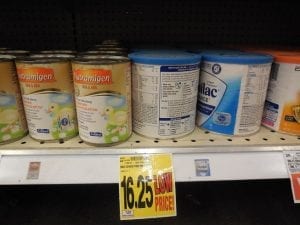 Cans of baby formula on the shelf of a store