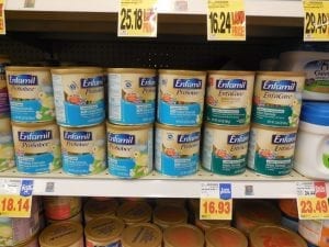 A photo of Enfamil baby formula stacked on the shelf of a store