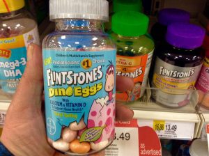 A bottle of Flintstones multivitamin, featuring the iconic Flintstones characters, providing essential vitamins and minerals for children's health