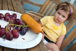 A Toddler refusing to eat the fruits and vegetables
