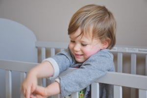 A baby in a crib.