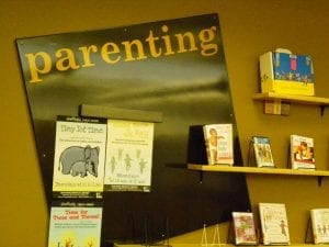 Best Book For New Parents: Parenting books section in a library with a variety of best books for parents on display.