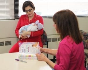 Best Books For New Parents: Consultation in progress with a baby, discussing best books for new parents.