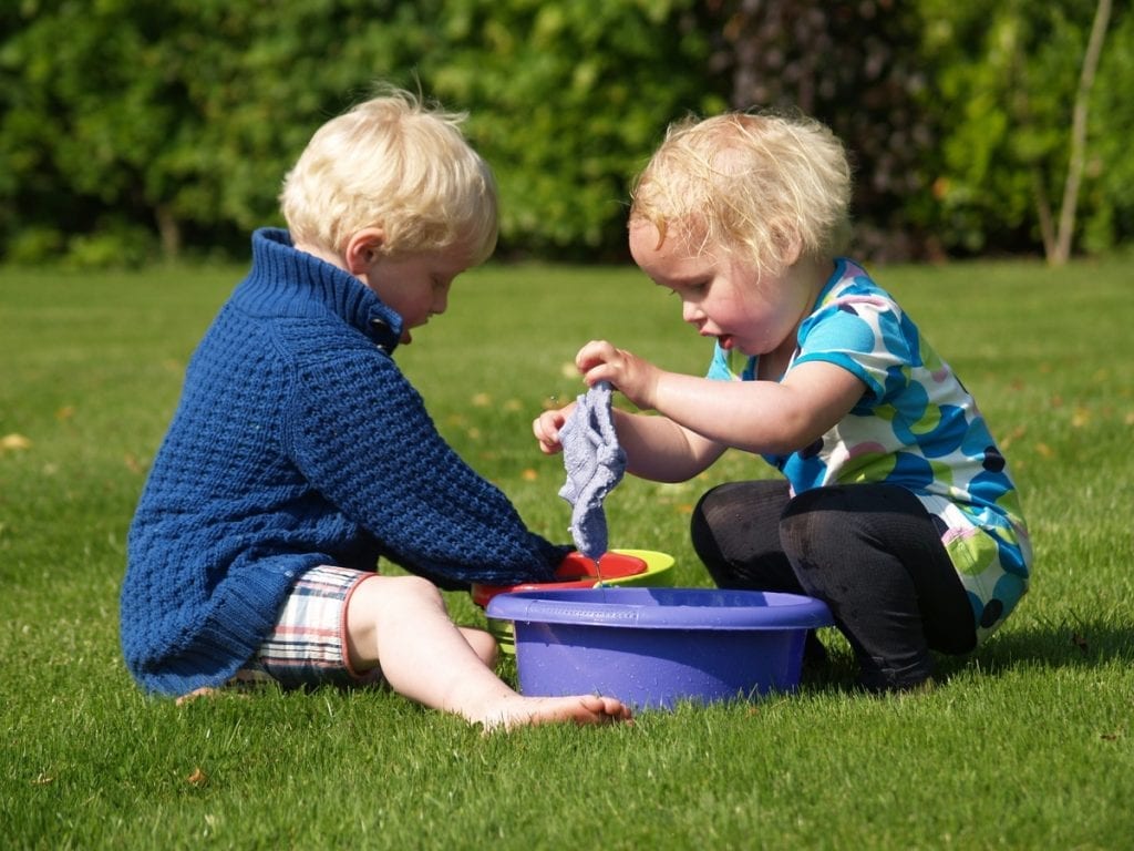 Best Bug Spray For Kids - Two kids playing together and having fun outside.