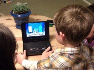 The best DVD player for kids. A photo of children watching movies on their DVD player. 