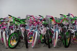 Colorful bike options for kids to choose from are arranged together in the corner of the room. 