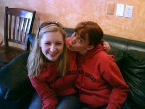 Two girls wearing best friend hoodies. 