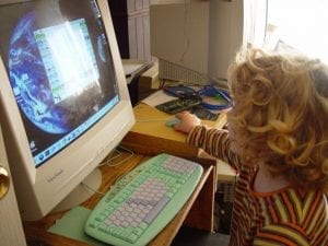 a kid types the computer