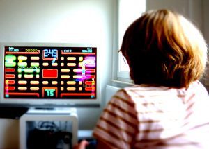 A child playing videogames similar to earlier versions of games available in the console.