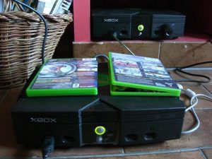 Xbox gaming console in color black with Xbox games on top.