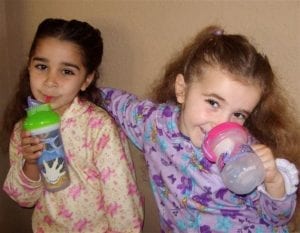 Two little girls enjoying a drink from their best cups, so lovely 