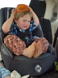 Boy using a car seat. 