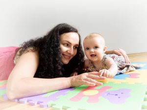 An image of the best baby play mat, providing a safe and comfortable space for playing and exploring. A loving mother engages with her child, ensuring quality care and joyful moments on the soft, supportive mat.