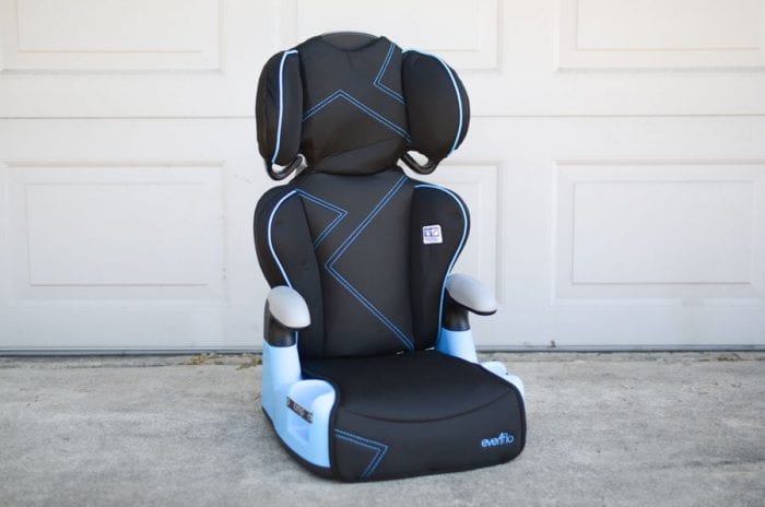A black booster car seat with blue lining.