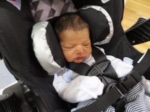 A baby sleeping in a Symphony car seat