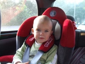 A happy baby on a nice type of car seat