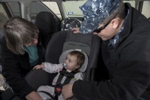 A father happy with his baby's nice type of car seats.