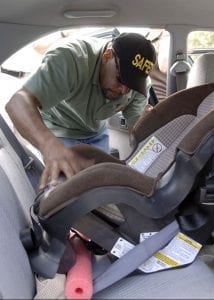 technician installing a car seat