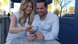 Man and woman looking for places online to visit for their special day.