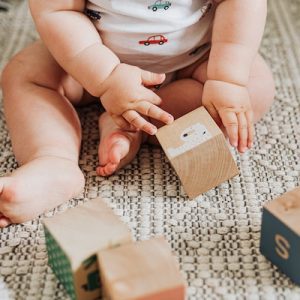 A joyful baby engaged in the best playtime, happily playing and exploring on a carefully crafted baby play mat, surrounded by a caring and safe baby environment.