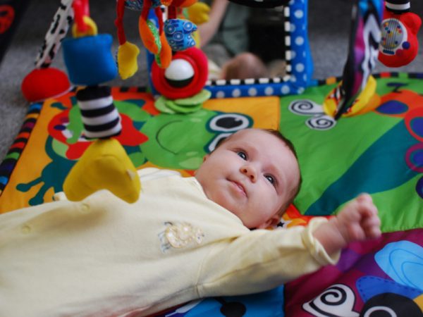 Little kid crawling safely in a mat
