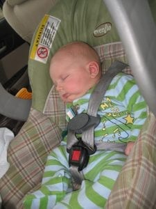 car seats - An infant sleeping in an affordable infant car seat.