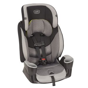 A gray and black Evenflo Maestro car booster seat for kids on a white background. The car booster seat has a black plastic base and a gray fabric seat with black mesh detailing on the sides and headrest. The headrest has two slots for the harness straps. The harness straps are black and gray, and they are buckled into the chest clip. The chest clip is black and gray, and it has a red release button. The car booster seat also has a cup holder on the right side.