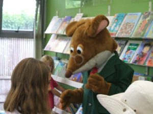 In a cozy store, a child stands enchanted, clutching a cherished teddy bear. Their eyes sparkle with joy and wonder as they explore the world of cuddly companionship. The child's smile radiates warmth, mirroring the comfort found in the embrace of their beloved teddy bear. It's a heartwarming scene that captures the innocence and magic of childhood.