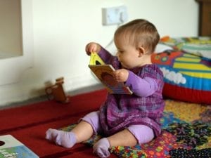 a baby reading the top touch and feel books