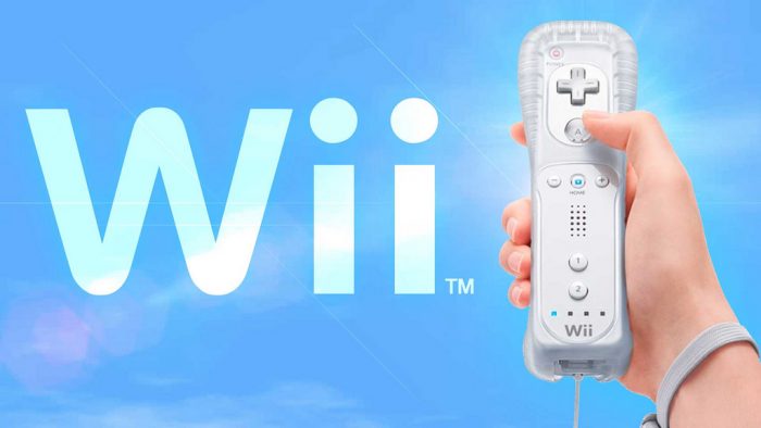 A hand holding a Wii remote control, getting ready to have fun game time with the whole family