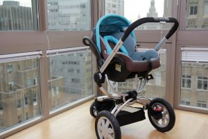 Best Car Seat Stroller Combo: An urban-ready car seat stroller combo positioned near a window overlooking the city, showcasing its best features for a comfortable and stylish ride.