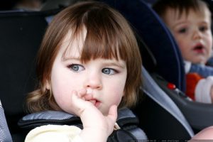 Kids use their car seat in the car.