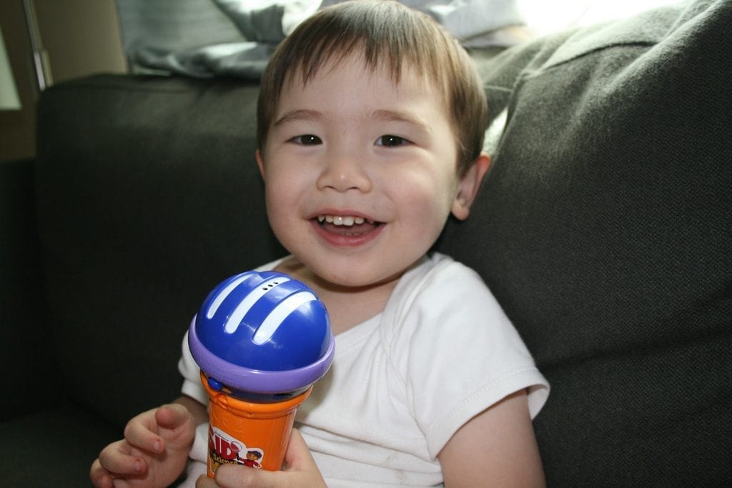 Kid's Microphone: Perfect for children who are interested in singing. Get the best microphone for kids. cute baby holding a toy with smile