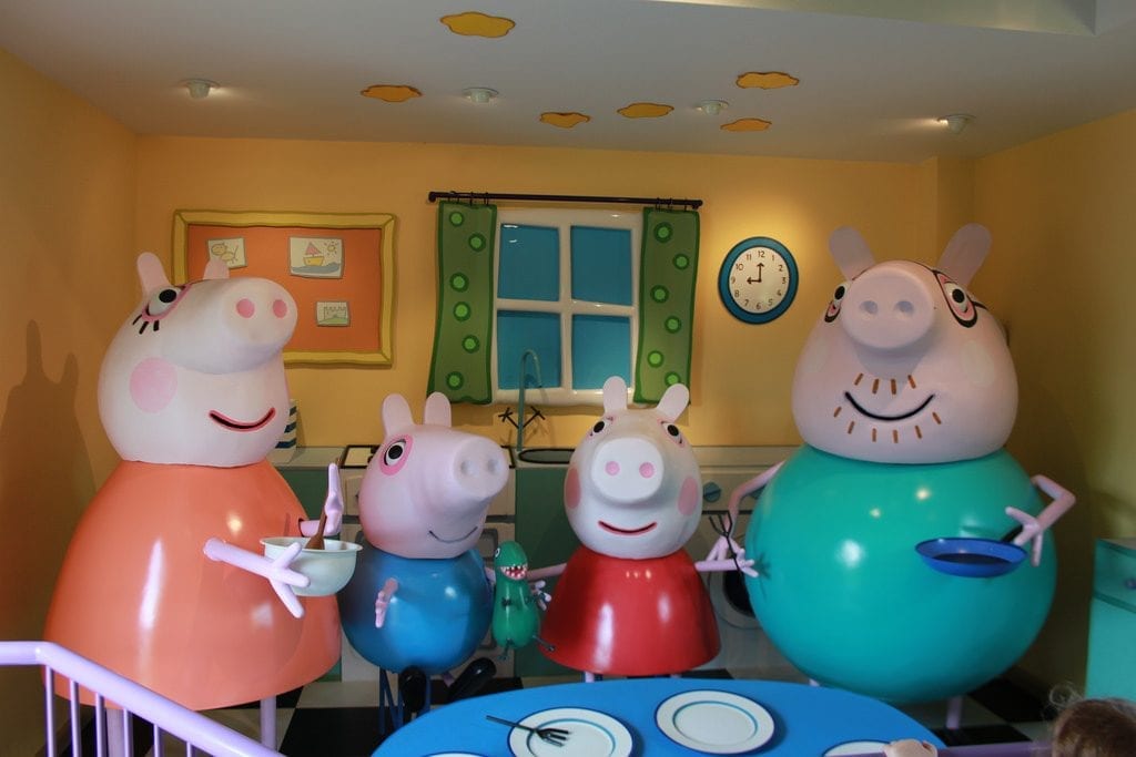 Peppa pig, George, and their parents at dining table