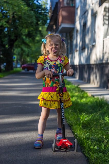 Toddler riding her best scooter