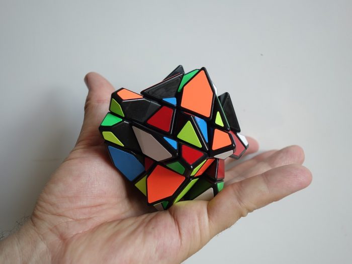 A girl plays with a Rubik's cube for the best educational yet fun-filled experience of a lifetime.