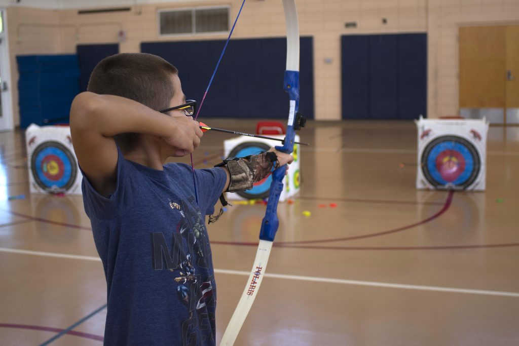 Child playing archery bow set