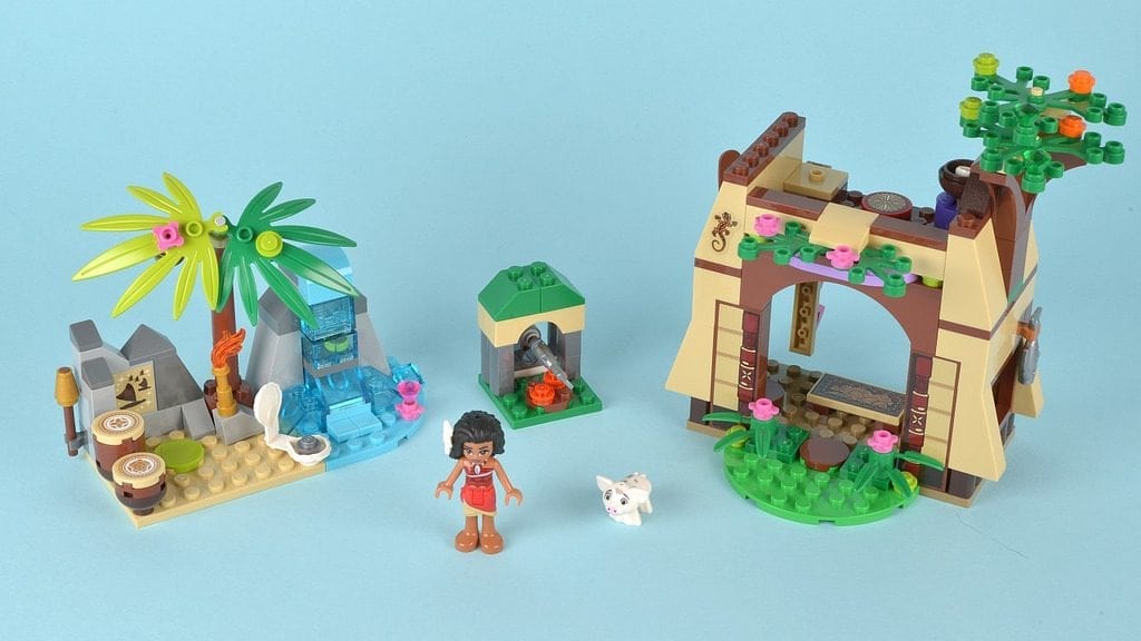 A LEGO Friends playset featuring an outdoor scene with a waterfall, palm trees, a hut, a mini-doll figure, and a small animal figure.