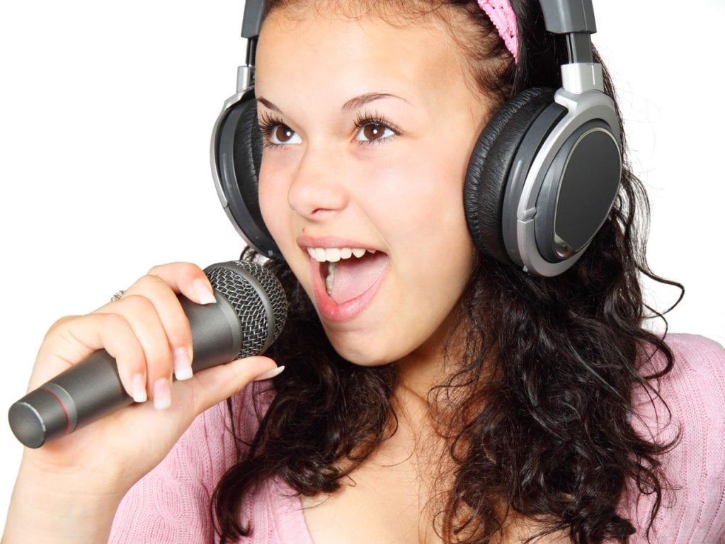 Girl singing with a microphone. What could be the best microphone for kids?